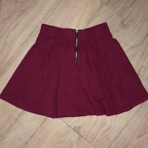 maroon skater skirt with gold zipper detail